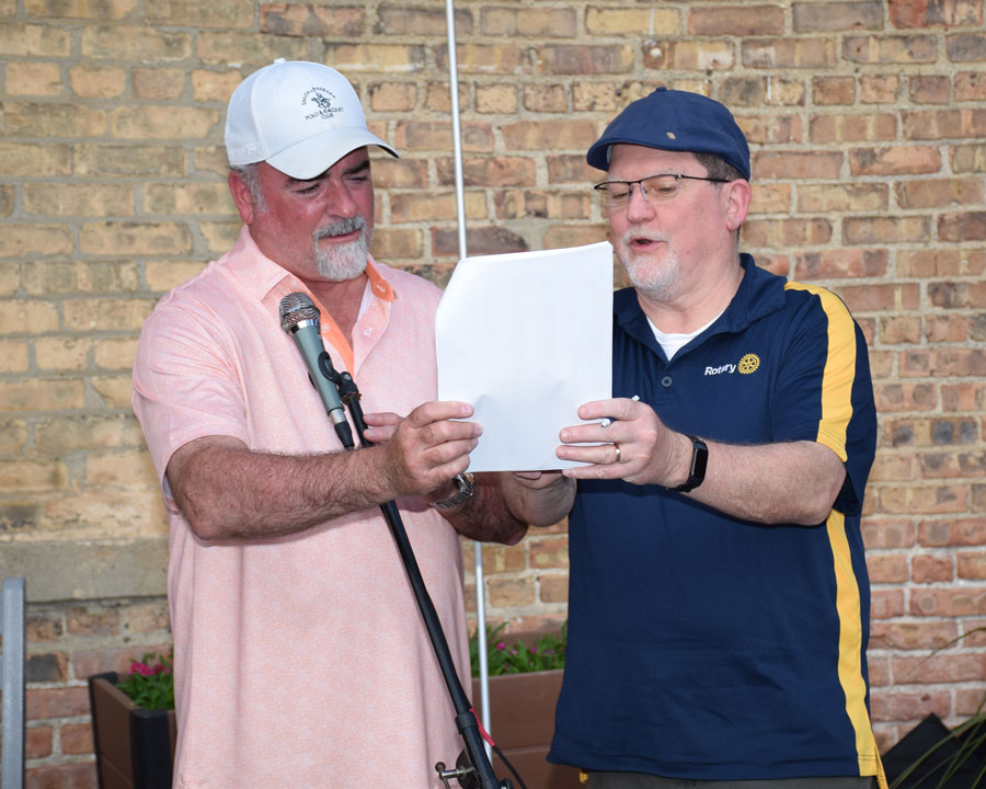 Woodstock Mayor Mike Turner and Woodstock Rotary Club President Joe McDonough confer on matching the winning number with Jodi’s name.